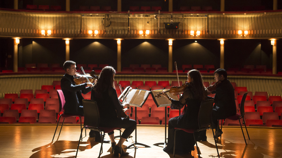 RCM string quartet playing on the stage of the RCM Britten Theatre